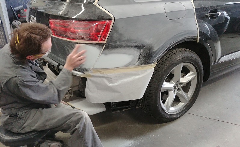 technician conducts site audit at autobody shop